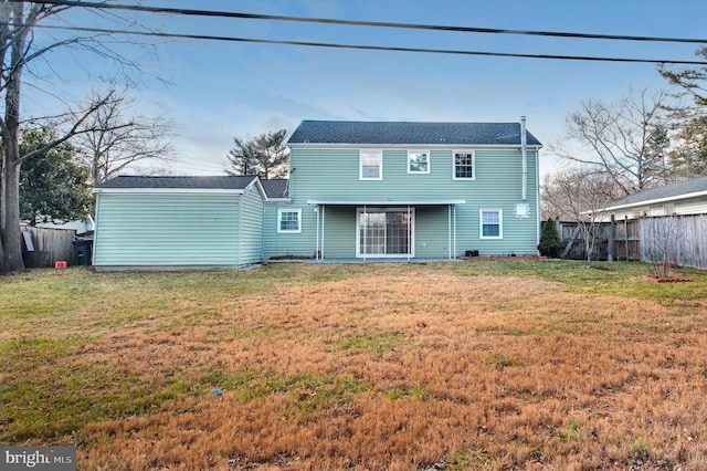 rear view of house with a yard