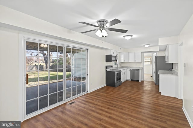 kitchen featuring a healthy amount of sunlight, white cabinetry, sink, and appliances with stainless steel finishes