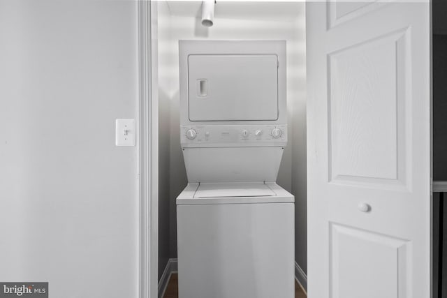 washroom featuring stacked washer and clothes dryer