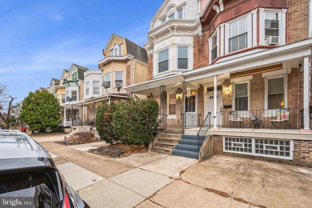 townhome / multi-family property with covered porch