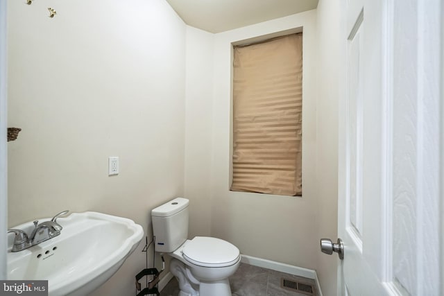 bathroom featuring tile patterned floors, sink, and toilet