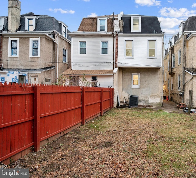 back of house with central AC