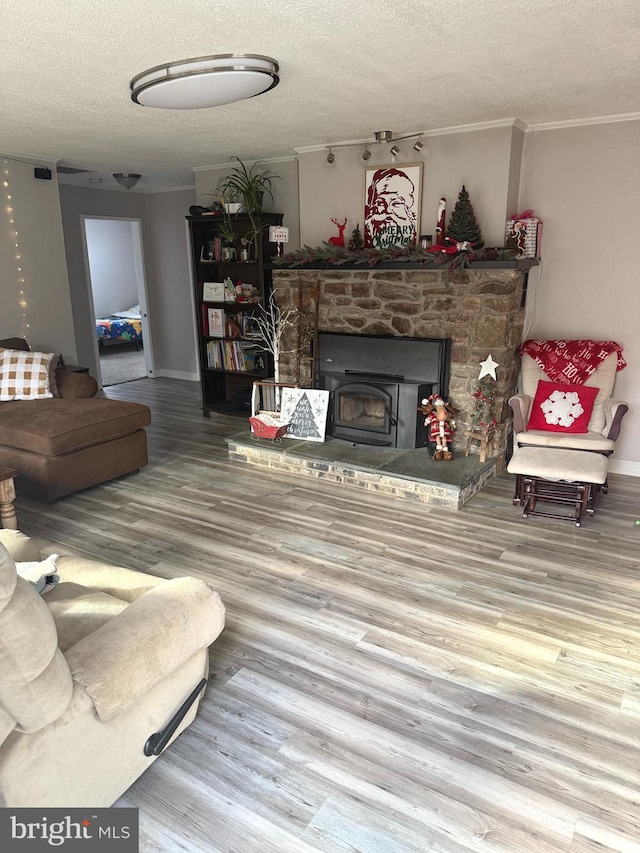 living room featuring a textured ceiling, hardwood / wood-style flooring, and crown molding