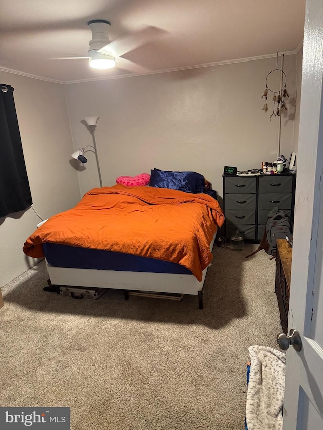 bedroom with carpet floors, ceiling fan, and crown molding