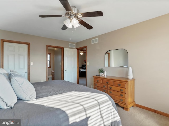 bedroom with ensuite bathroom, ceiling fan, and light colored carpet