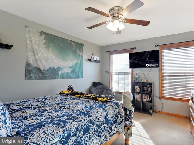 carpeted bedroom featuring ceiling fan