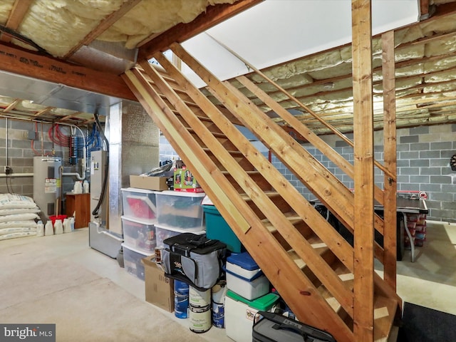 unfinished attic featuring water heater