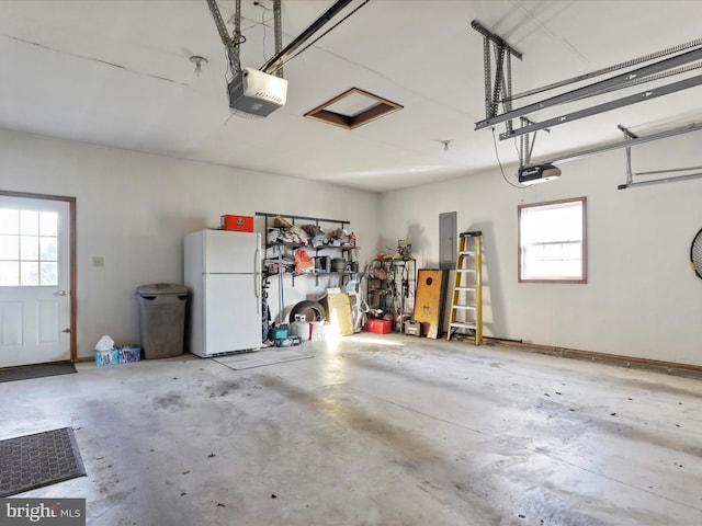 garage with electric panel, white fridge, and a garage door opener