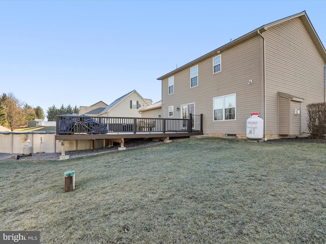 back of property featuring a yard and a wooden deck