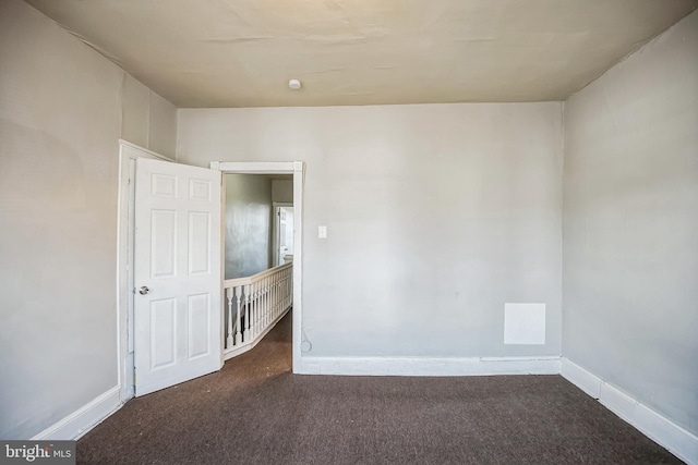 empty room featuring dark carpet