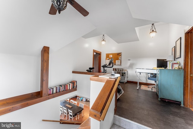 interior space featuring ceiling fan, dark wood-type flooring, and lofted ceiling