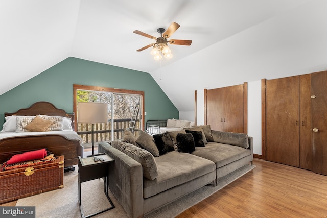 living room featuring ceiling fan, light hardwood / wood-style floors, and lofted ceiling