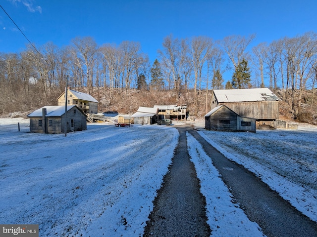 yard covered in snow featuring an outdoor structure