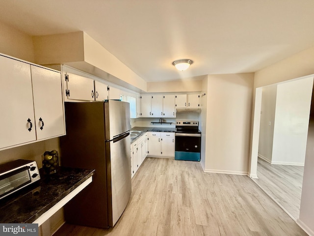 kitchen featuring light hardwood / wood-style flooring, white cabinets, stainless steel appliances, and sink