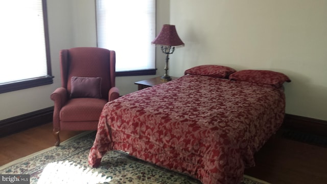 bedroom with wood-type flooring