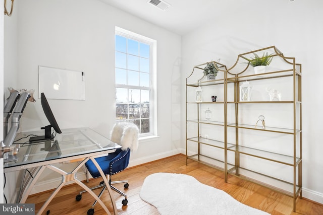 office area with wood-type flooring and a wealth of natural light