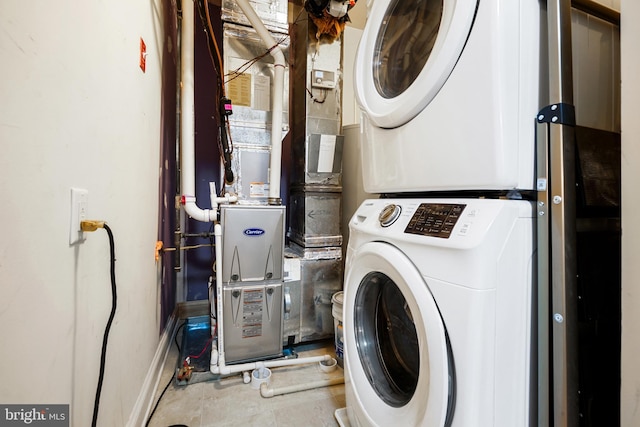 laundry room with tile patterned floors and stacked washer and clothes dryer