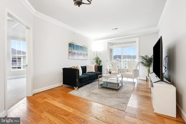 living room with crown molding and light hardwood / wood-style floors