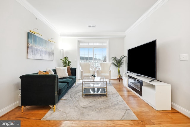 living room featuring wood-type flooring and ornamental molding