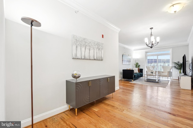 corridor featuring ornamental molding, a notable chandelier, and light wood-type flooring