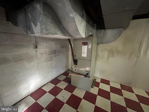 utility room featuring heating unit