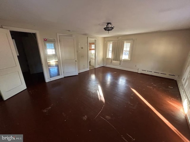 interior space featuring baseboard heating and dark wood-type flooring