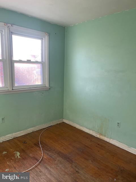 spare room with wood-type flooring