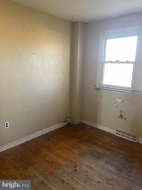 spare room featuring dark hardwood / wood-style flooring