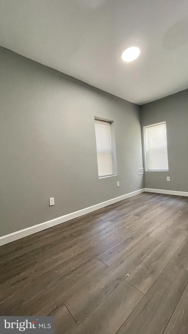 spare room featuring hardwood / wood-style floors