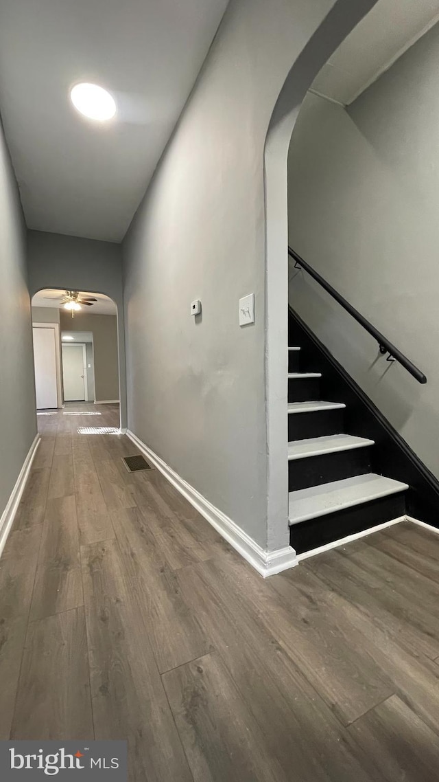 corridor with hardwood / wood-style floors