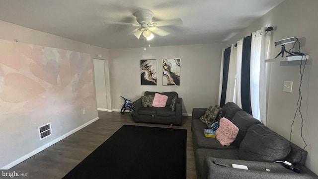 living room with ceiling fan, wood finished floors, visible vents, and baseboards