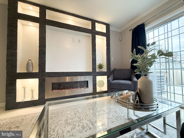 sitting room with crown molding and a fireplace