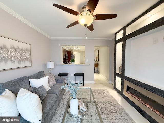 living room with ceiling fan and crown molding