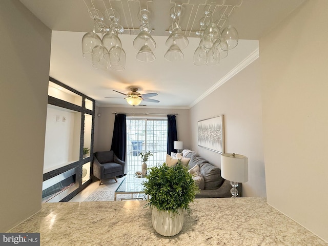 living room featuring ceiling fan and ornamental molding