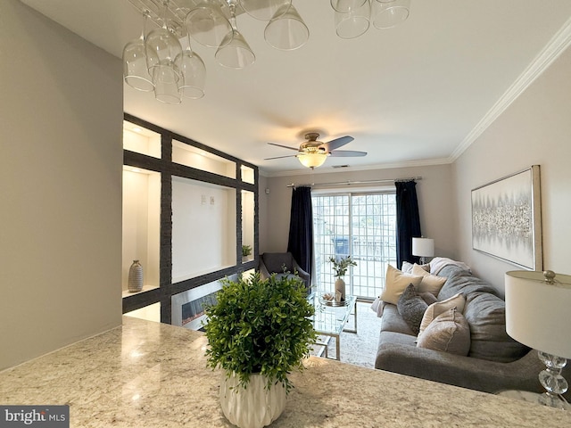 living room featuring ceiling fan and crown molding