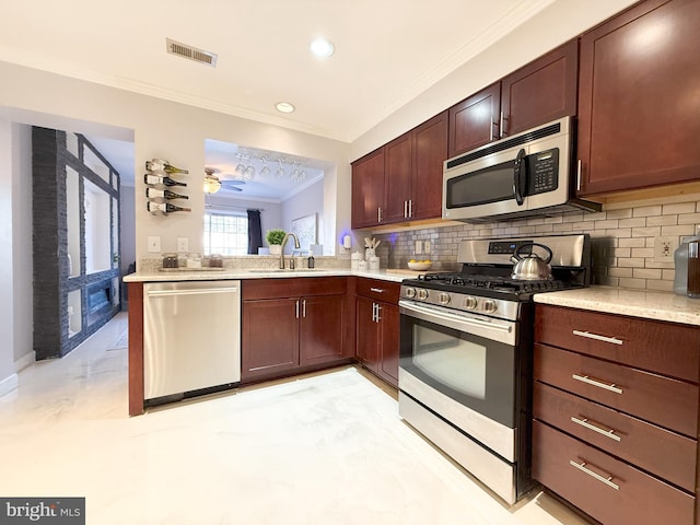 kitchen featuring backsplash, crown molding, sink, and stainless steel appliances