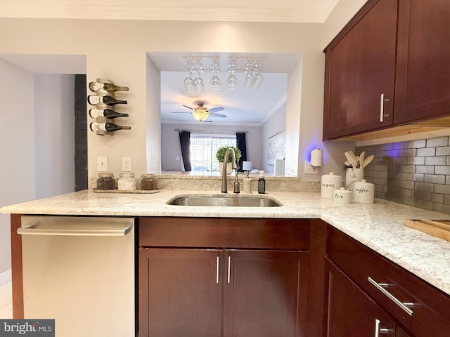 kitchen with kitchen peninsula, stainless steel dishwasher, ceiling fan, crown molding, and sink