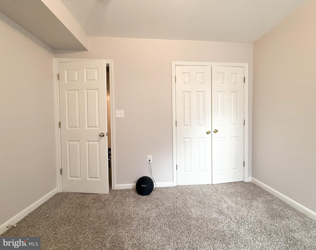 unfurnished bedroom featuring carpet floors and a closet