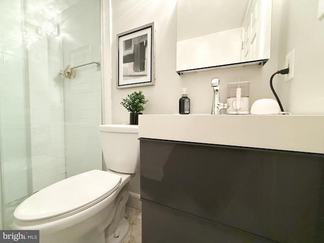 bathroom with walk in shower, vanity, and toilet