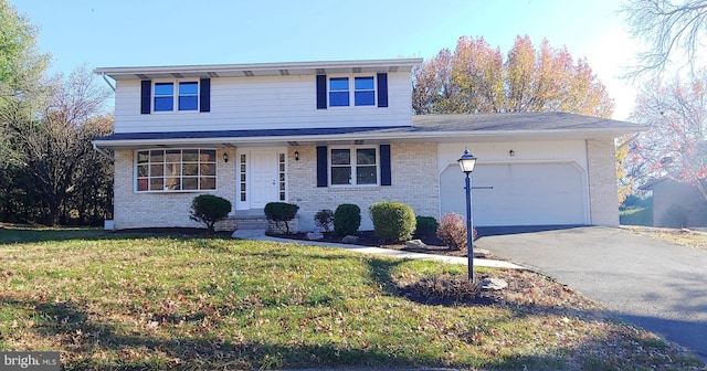 view of front property with a front yard and a garage