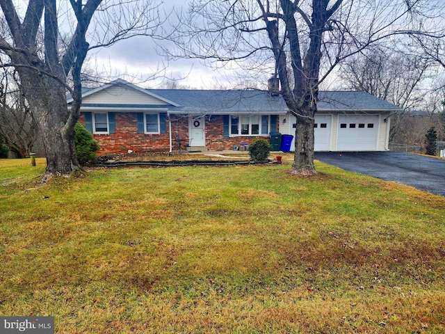 ranch-style house featuring a front lawn and a garage