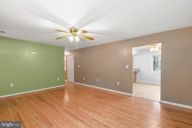 spare room with ceiling fan and light hardwood / wood-style flooring