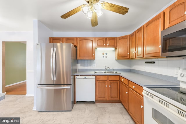 kitchen with ceiling fan, appliances with stainless steel finishes, decorative backsplash, and sink