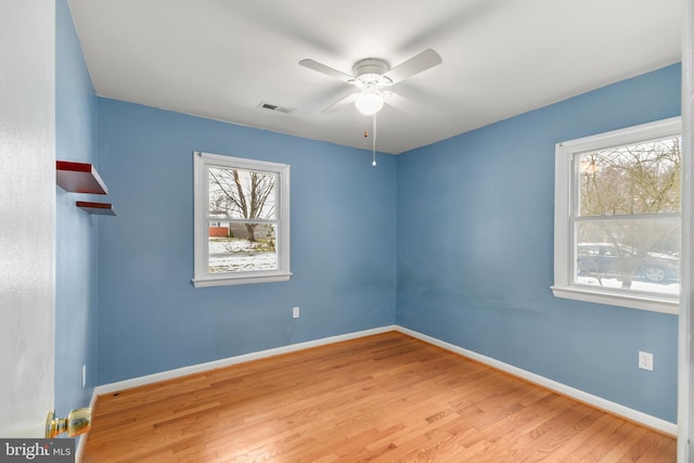 empty room with ceiling fan and light wood-type flooring