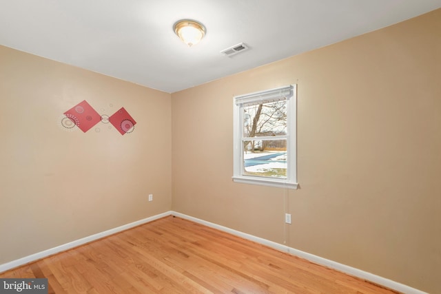 spare room featuring hardwood / wood-style flooring