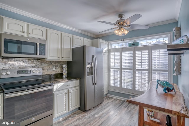 kitchen featuring white cabinets, ceiling fan, crown molding, and appliances with stainless steel finishes