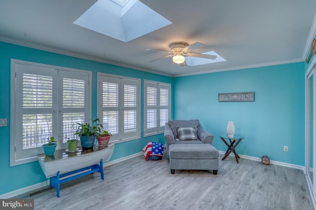 living area featuring light hardwood / wood-style flooring, ceiling fan, and ornamental molding