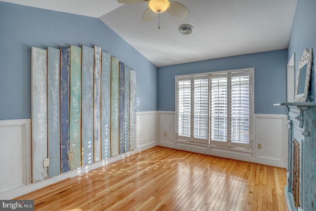 interior space with ceiling fan, vaulted ceiling, and light hardwood / wood-style flooring