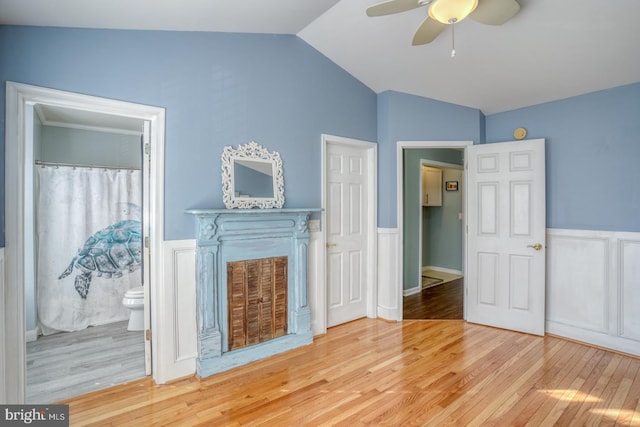 unfurnished living room featuring hardwood / wood-style flooring, ceiling fan, and lofted ceiling