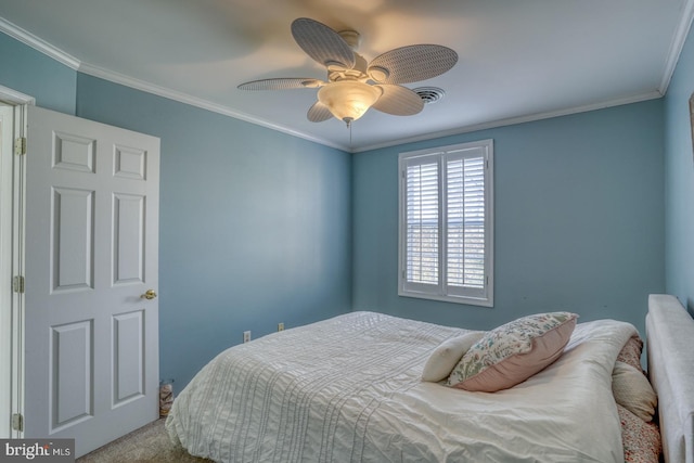 bedroom with ceiling fan, crown molding, and carpet floors